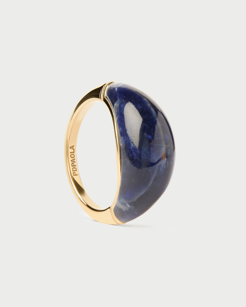Chunky stamp ring topped with an oval hand-carved royal blue gemstone