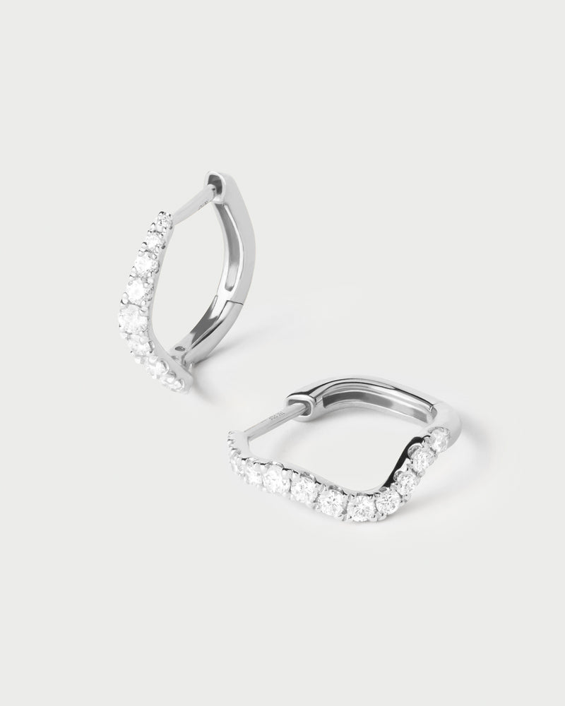 Fluid half eternity hoops in white gold featuring an undulating row of lab-grown diamonds