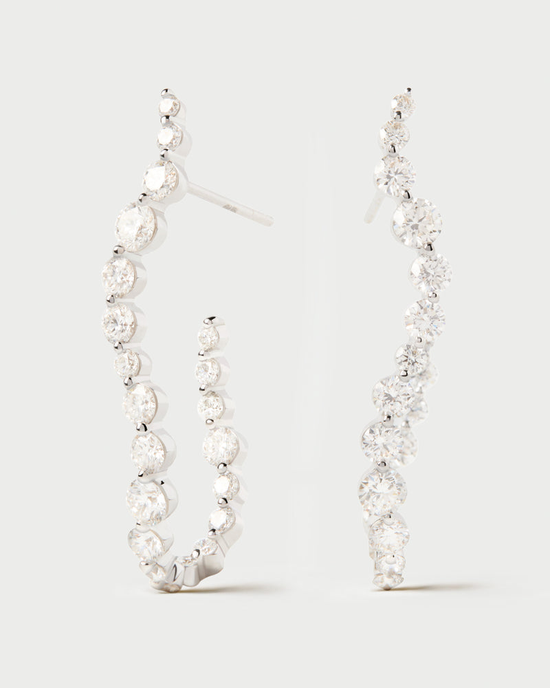 Elegant large semi hoops in 18K white gold featuring an undulating line of lab-grown diamonds